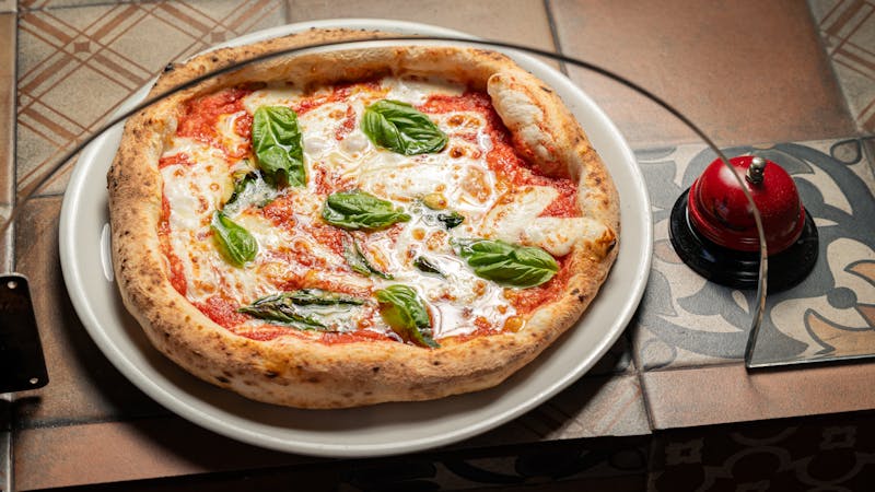 Classic Margherita pizza with fresh tomatoes and mozzarella